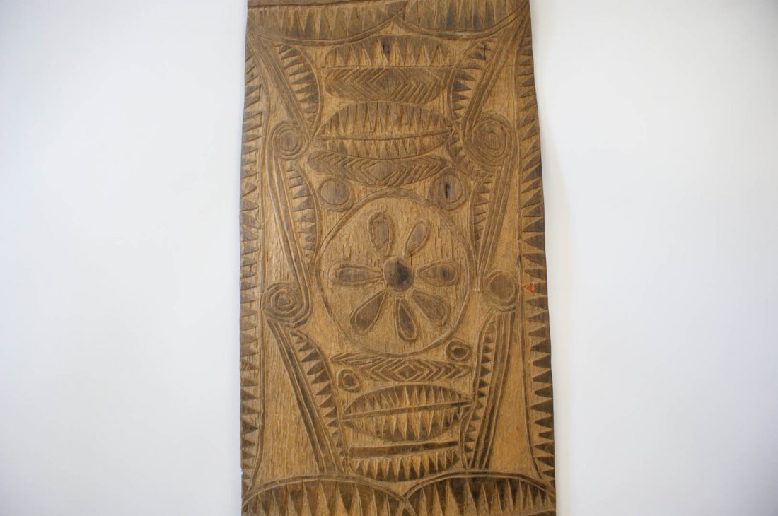 LARGE CARVED WOODEN SHEILD, NEW GUINEA: Carved designs of leaves and flowers. 61 x 14 inches.