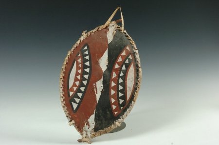 MAASAI CHILD'S SHIELD, EAST AFRICA: Hide covered wood frame painted the typical red, white and black, 15 x 9.5 inches.