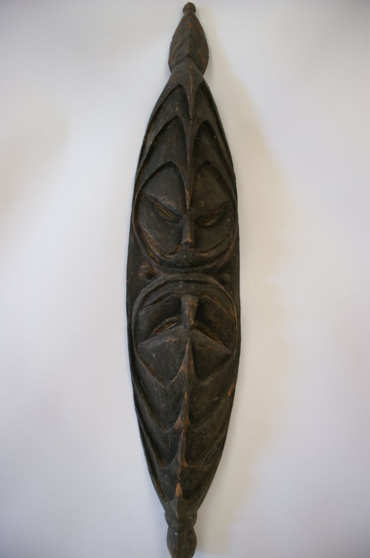 RAMU RIVER MASK, NEW GUINEA: Carved wood mask representing a pair of ancestors. By looking up and down at each other, they ward off evil. 36 inches.
