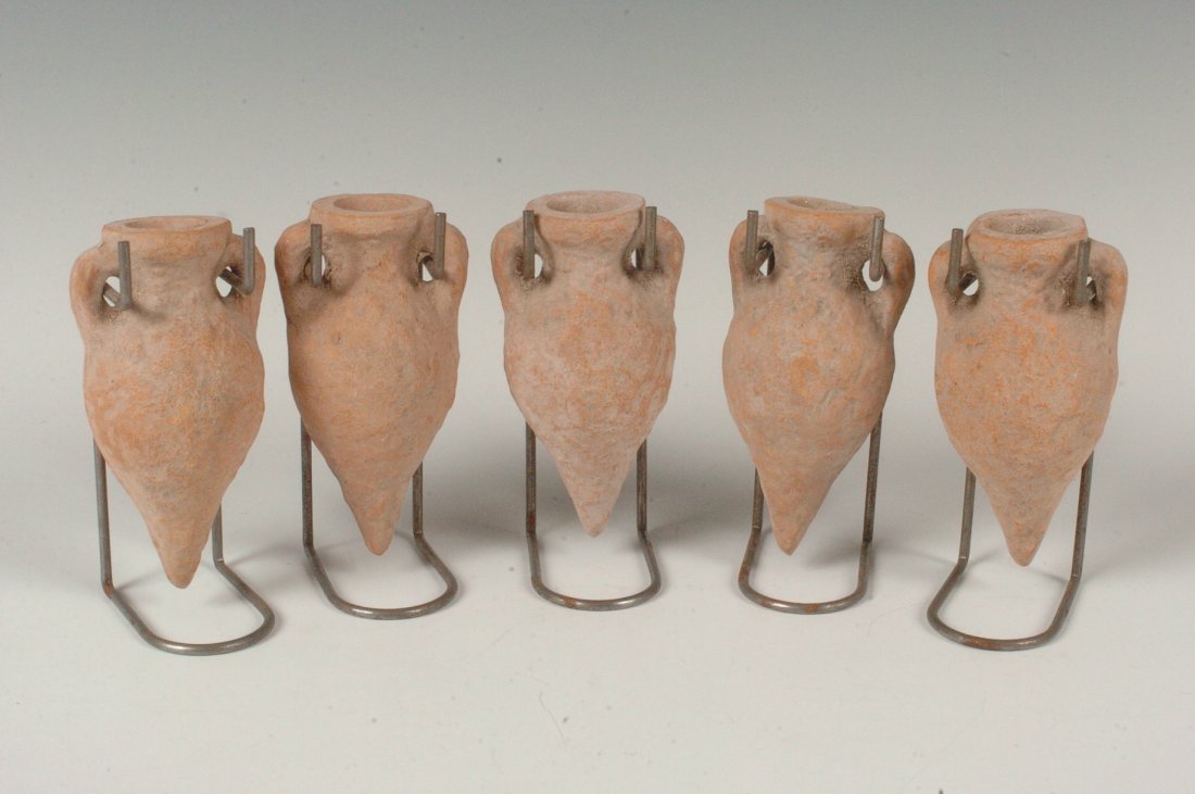 FIVE CLAY AMPHORAS, HOLY LAND: Terra cotta two-handled amphora with stands. 4 inches each. Not guaranteed to be ancient, but assumed to be reproductions.