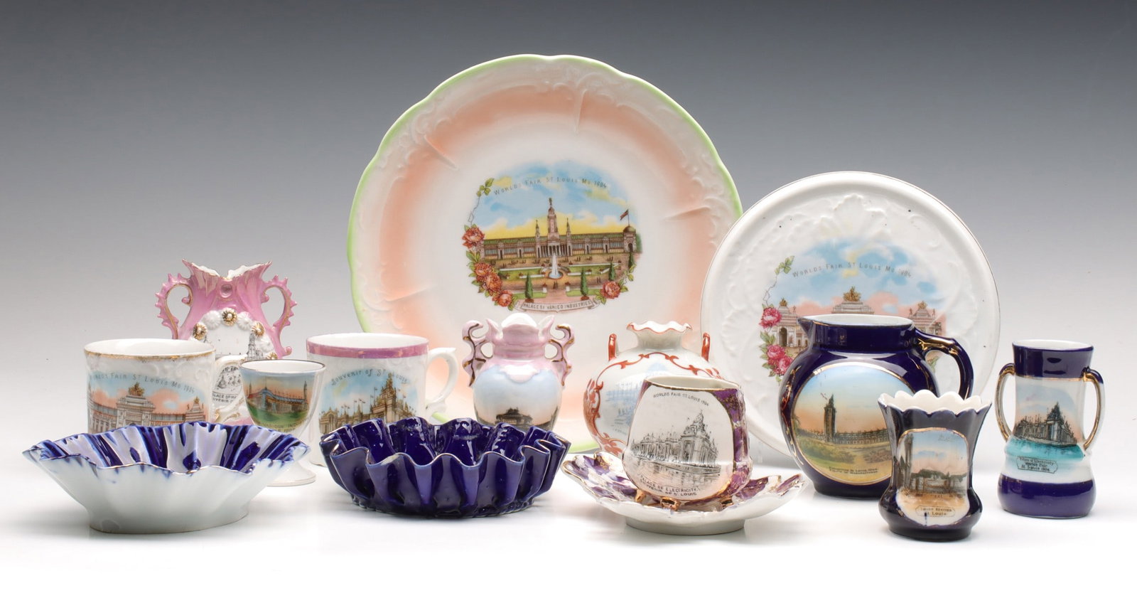 A COLLECTION OF 1904 WORLD'S FAIR PORCELAIN SOUVENIRS: The collection of plates, bowls, vases and cups as shown. Measures from 2.25 x 8.75 inches. Without proof of exemption, be aware that internet sales tax applies to all Internet transactions and local 