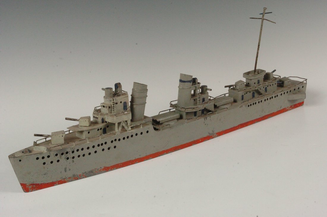 FOLK ART / TRENCH ART MILITARY SHIP MODEL: Folk art or trench art Military ship, made of light steel or thick tin. Measures 7.5 x 23 inches.