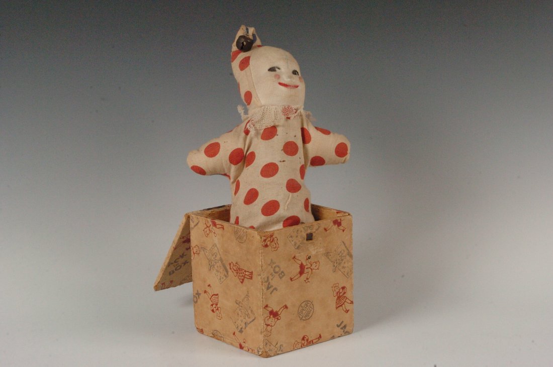 PAPER ON WOOD JACK-IN-THE-BOX TOY: Early Jack in the box, wood covered with paper litho, kids playing, Jack is a cloth covered clown, push him down lock top, push button to make him pop up. 12 x 6.5 inches