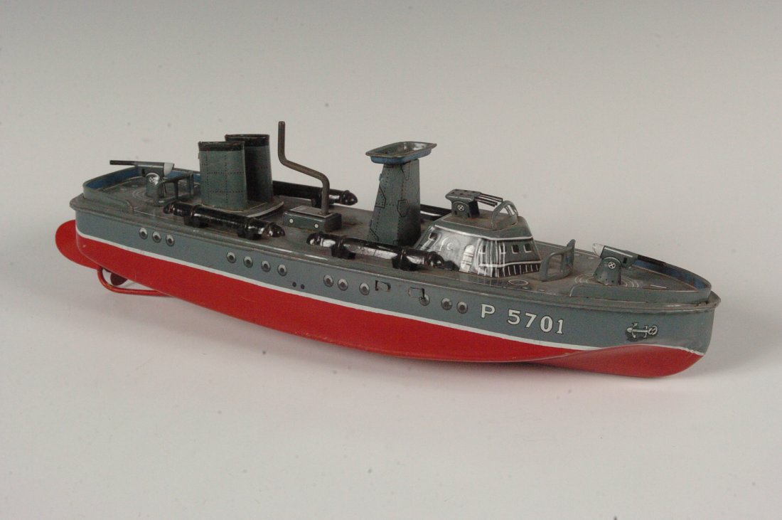 PT 107 CRANK OPERATED TIN TOY TORPEDO BOAT: Torpedo Boat,crank up tin toy, marked N Japan. Measurements 3.25 x 12 inches including rudder.