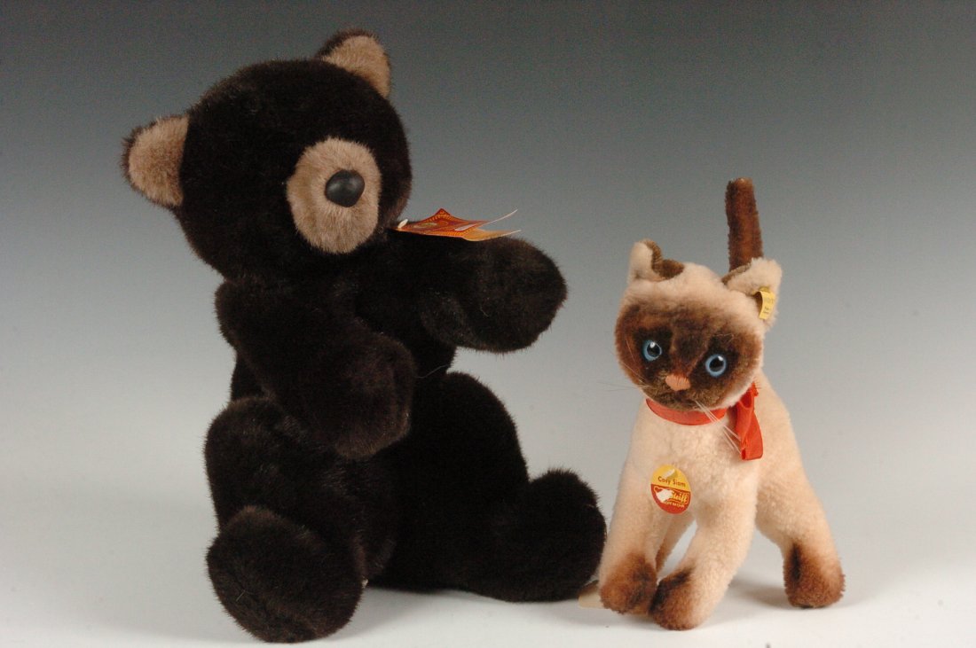 STEIFF 'COSY SIAM' CAT: A Steiff cat with a tag marked 'Cosy Siam' original Steiff 5110/22 measuring 10.5 x 6 inches, and a bear with a tag marked Lenci with the measurements of 15 x 9.5 inches
