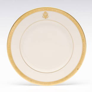 FERDINAND MAGELLAN PRESIDENTIAL TRAIN PLATE: The gold encrusted bread and butter plate with border design of stars and bars is centered by the Great Seal of the United States on the rim, signed by green Syracuse China Old Ivory backstamp. The