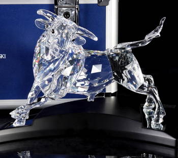 SWAROVSKI LIMITED EDITION BULL ON STAND WITH BOXES: Bull, 00754/10000 numbered limited edition, comes with mirrored platform and locking carrying case, brochure, and gloves as pictured. Bull measures 8 x 9.75 x 5 and the case is 10.25 x 16 x 13 inches.