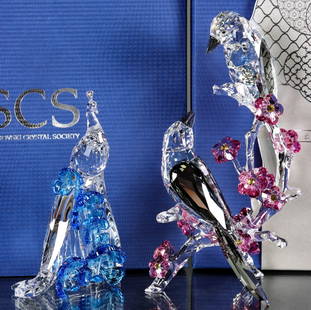 TWO SWAROVSKI CRYSTAL FIGURES WITH BOXES: 1. SCS White Peacock 5063695 is signed and comes with all boxes. 2. The Tutelary Spirit-Loving Magpies 5004639 comes with brochure and all boxes as pictured. White Peacock measures 5 x 3.25 x 2 and th