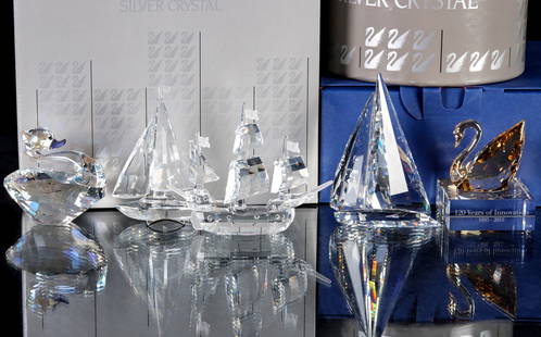 FIVE SWAROVSKI CRYSTAL FIGURES WITH BOXES: 1) Santa Maria, 000003, measures 3.5 inches. 2) Sailboat, 000004, measures 3.75 inches. 3) Sailing Legend, 000006, measures 4.125 inches. 4) Swan Event Piece 2015, 5137830, measures 3.125 inches.