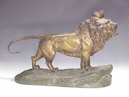 Bronze sculpture of male lion: two color finish patinated gold and brown lion measuring 23" on a green naturalistic base signed R Bousquet for Robert Bousquet (1894-1917)