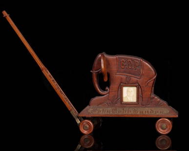 A 1933 KANSAS PRISON FOLK ART GIFT TO GOVERNOR'S SON: The carved walnut folk art pull toy with a political agenda was made by an inmate of the Kansas state penitentiary in Lansing for the son of then Governor Alf Landon. It was later purchased from the