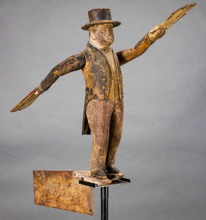 AN IMPORTANT 19TH CENTURY AMERICAN FOLK ART WHIRLIGIG: The fine and rare mid 19th century example of carved and painted pine depicts a gentleman in black top hat and tail coat with mustard colored waistcoat above brownish red trousers. The figure, though