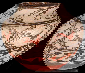 A 19TH CENTURY ZUNI PUEBLO POTTERY OLLA WITH RED BASE: The nice, large olla with convex collar above the swollen shoulder is decorated by a band of repeating stylized bird figures in geometric reserves above traditional designs and an unusual base finish