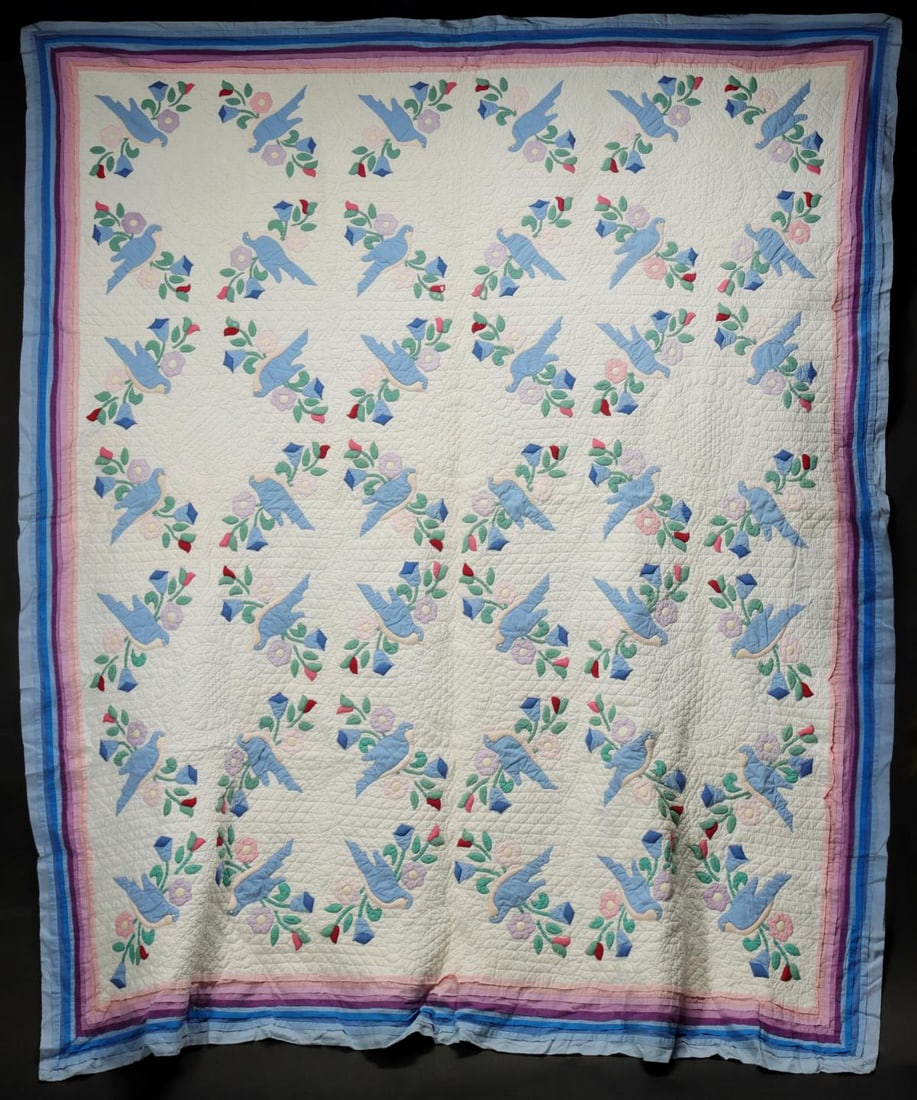 A HIGHLY STUFFED TRAPUNTO BLUEBIRD APPLIQUE QUILT: The forty-one skillfully arranged and hand quilted trapunto designs of bluebird and flower wreaths - all interlocking and completing one another in a clever way - are composed in applique of stuffed, 