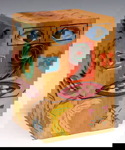 A MID 20TH CENTURY CARVED AND PAINTED FOLK ART STAND: The block of joined wood having grain like maple is intaglio carved and painted with bold, deep features, and further decorated in etched designs and brightly colored paints - presumably the symbols o