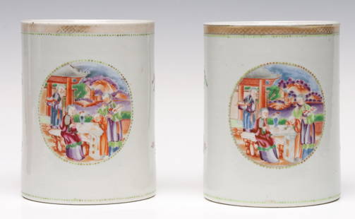 A PAIR 18TH CENTURY CHINESE EXPORT PORCELAIN TANKARDS: Each large, cylindrical body is decorated with hand painted genre scenes in oval reserve and spare sprigs in enamel decoration banded in green beading and a gold tracing over a salmon band at the rim.