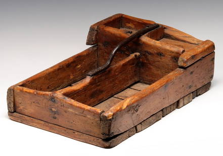 A PRIMITIVE 19C. AMERICAN SQUARE NAILED PINE TOOL TOTE: The divided tote is mounted with a forged iron handle. Measures 6.25 x 19.5 x 13.25 inches. Provenance: Private Collection Denver, Colorado. Without proof of exemption, be aware that internet sales ta