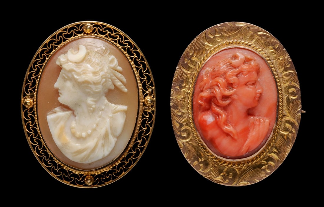 CIRCA 1900 CARVED CORAL AND SHELL CAMEOS IN KARAT GOLD: 1. A carved shell cameo in 10k gold filigree bezel is set with both bail and pin, marked 10K on the clasp. 2. A carved coral cameo brooch in hand engraved gold bezel, unmarked though stamped with pote