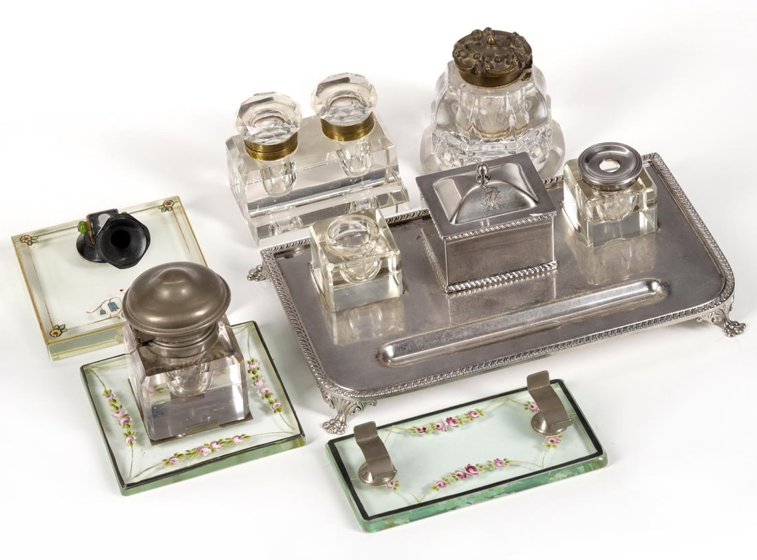 A COLLECTION OF VARIOUS TYPE ANTIQUE INKWELLS & STANDS: The entire lot as shown. Measures from 3.25 to 9 inches wide. Without proof of exemption, be aware that internet sales tax applies to all Internet transactions and local sales tax may apply to local p