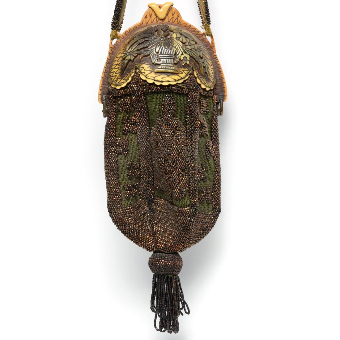 UNUSUAL PURSE WITH CARVED BAKELITE AND CARNIVAL BEADS: The unusual evening bag is topped by a carved bakelite shell over the embroidered bag beaded in carnival glass beads depicting a standing figure in frame, perhaps the goddess Quan Yin. Measures 12 x 5