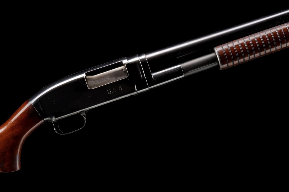 US MILITARY WINCHESTER 12GA MODEL 12 PUMP RIOT SHOTGUN: Winchester 12 gauge Model 12 (serial #:979224) Serial number places the year of production at 1945. The barrel and receiver are stamped U.S. with flaming bomb marks, and further stamped 2 3/4 CHAMBER 