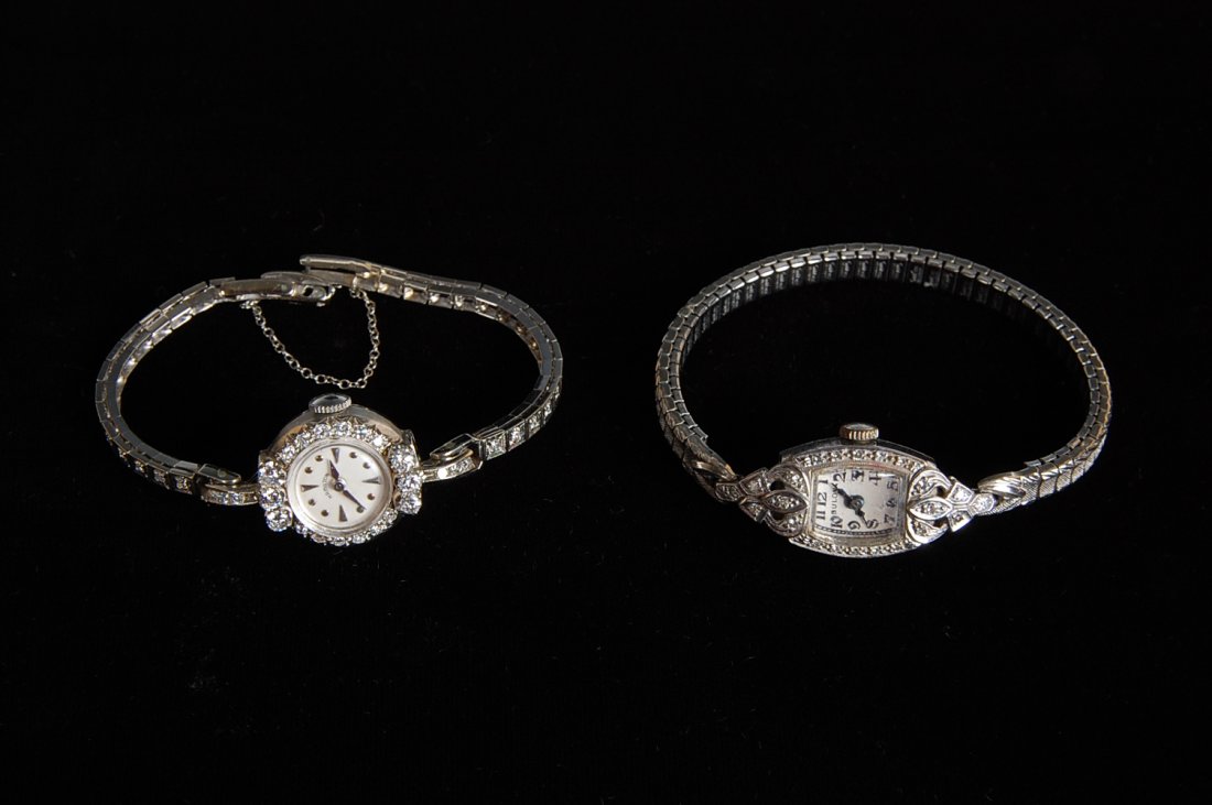 TWO LADIES WRIST WATCHES WITH DIAMONDS: 14K AND PLATINU: One Hamilton Ladies watch with diamonds, 14k gold case, base metal band, 16 grams total weight. Plus a Bulova platinum wrist watch with diamonds and 14k gold band also set with diamonds, total weight
