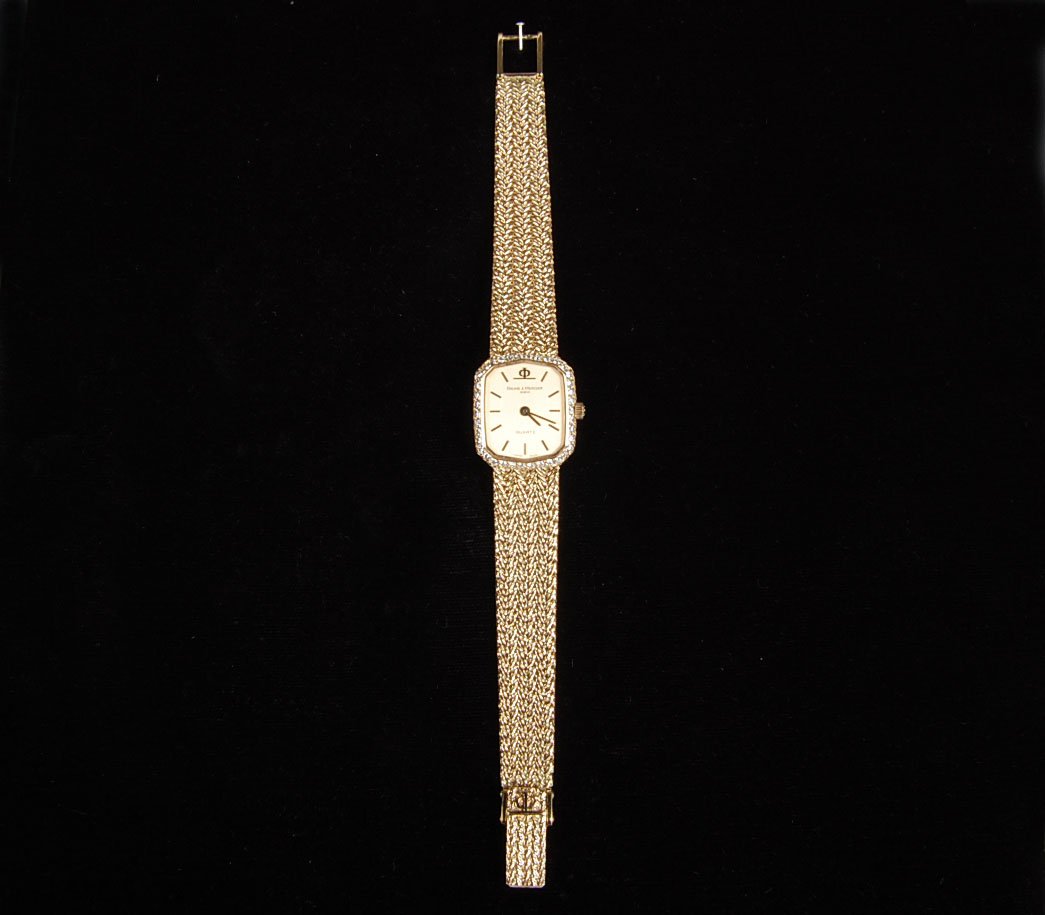 BAUME & MERCIER 18K GOLD AND DIAMOND WATCH W/18K BAND: Purchased at Bucherer in Lucerne, Switzerland, stamped 18k case and band, weight of 30 grams.