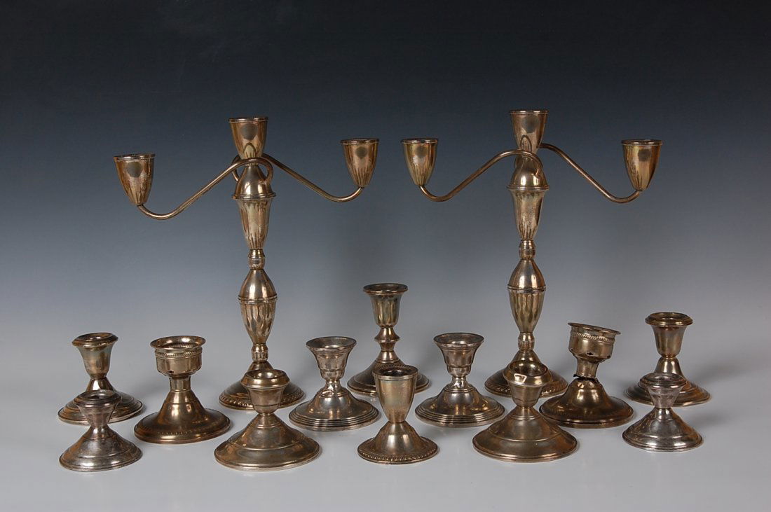 ESTATE LOT OF WEIGHTED STERLING CANDELABRAS AND CANDLES: Includes a matching pair of nice sterling candelabras, marked 'Duchin Creation' to weighted bases. Stand 11.5 inches, 10.5 inches across. Also twelve other candlestick bases, similarly sterling marked