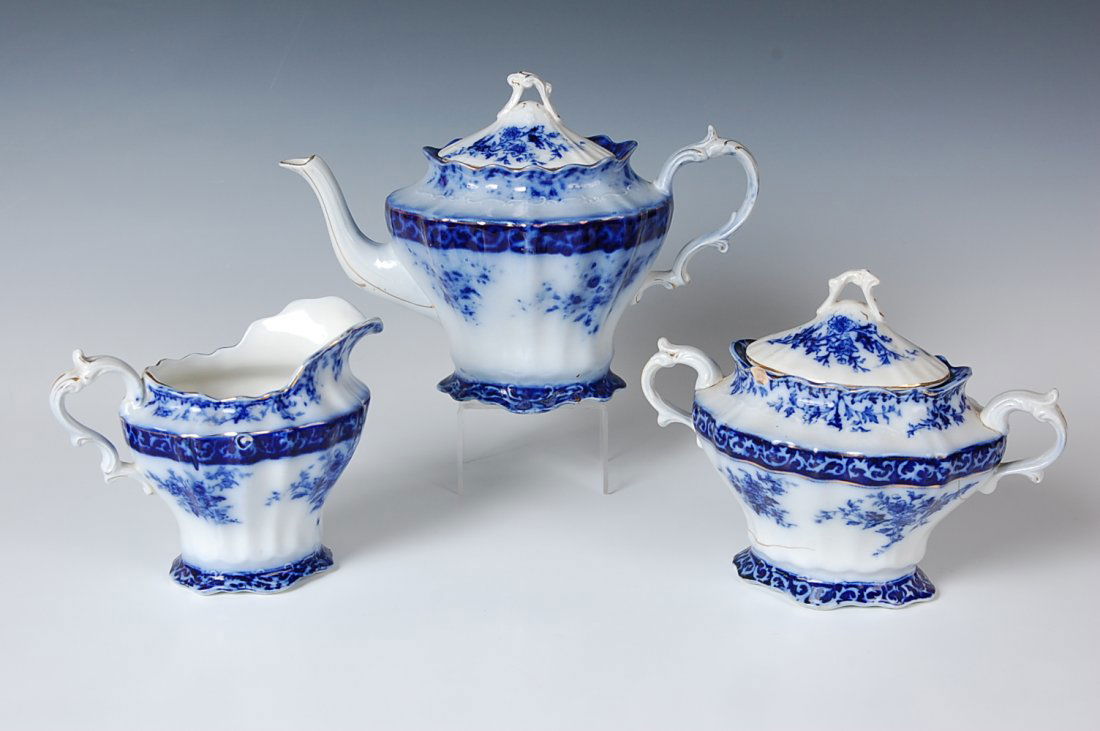 THREE 'TOURAINE' PATTERN FLOW FLOW BLUE CHINA SERVING P: All by Henry Alcock & Co. Includes a lidded teapot, 7 x 10.25 inches. Lidded sugar, 6 x 8 x 5.25 inches. Also a 5 x 6.25 x 4.25 inch creamer.
