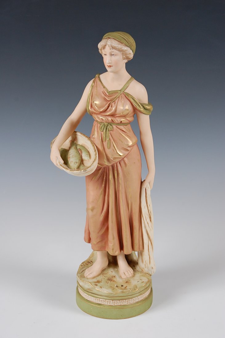 ROYAL DUX FIGURE WOMAN WITH FISHES: Figure of a woman in a pinkish gown, holding a basket of fishes, base with Greek key border. Base with Royal Dux triangle seal, incised 2123 and IX. Initials 'AH' on back of figure. Stands 15 inches.