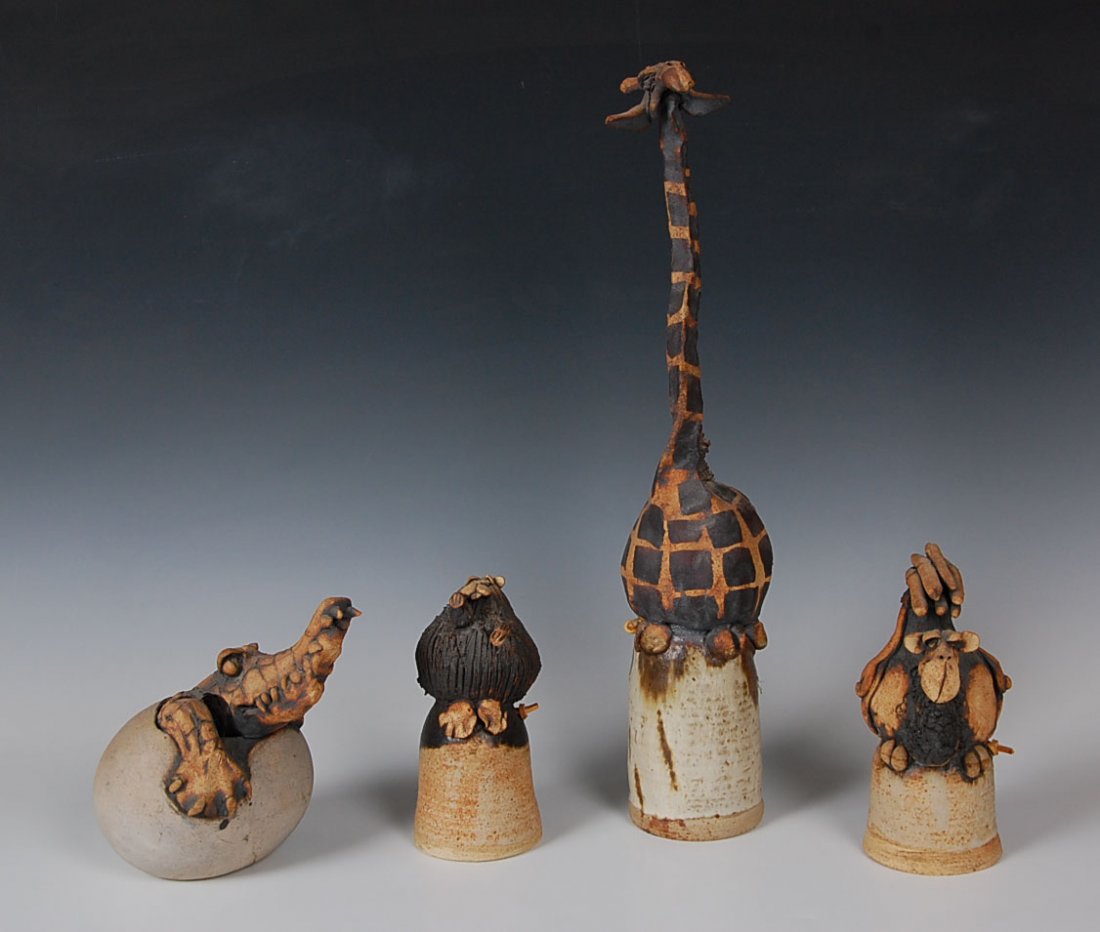 TODD WARNER (1945- ) POTTERY BELLS AND DECORATOR: Four unique pieces of pottery, including a giraffe bell, 18.75 inches high; a camel bell, 7.5 inches; beaver bell, 7 inches; and a crocodile hatchling, 7 inches high. Each signed Todd Warner.