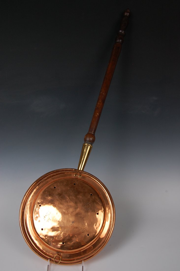 19TH CENTURY BRASS AND IRON BED WARMER: Nice hinged lid copper bed warmer with turned wood handle. Copper pan, brass collar, wooden handle, measures 3.5 inches high, 43.5 inches long overall.