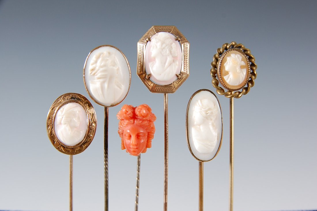 SIX ANTIQUE STICK PINS WITH CARVED SHELL CAMEOS: Five are carved shell, one is carved coral