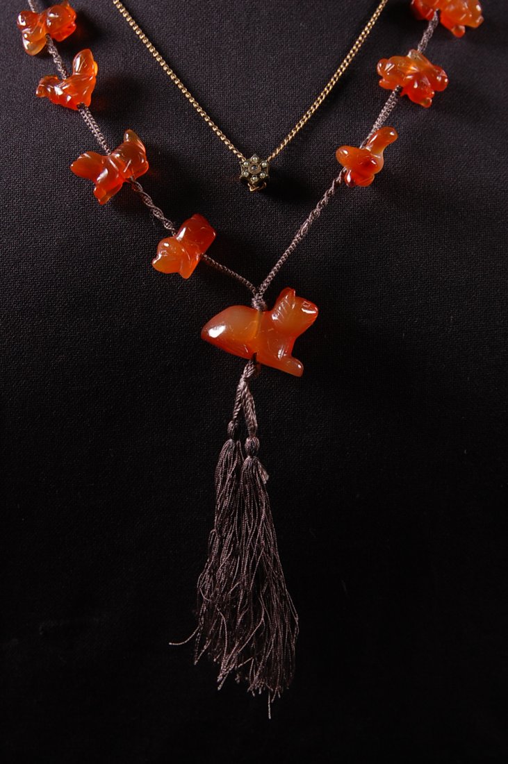 VICTORIAN SLIDE CHAIN & CHINESE CARVED CARNELIAN ANIMAL: A Victorian gold filled watch chain with slide set with seed pearls and tiny diamond. Plus a silk cord necklace with larger carved cat figure and other animals that include snake, rabbit, rooster, dog