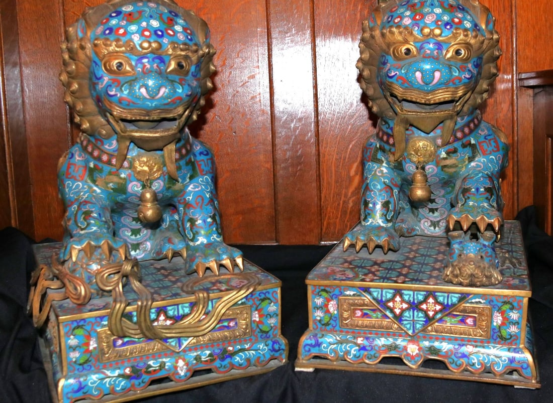 A FINE PAIR OF CHINESE CLOISONNE ENAMEL BUDDHIST LIONS: Each richly decorated and gilded figure stands on an integral rectangular base plinth; one with a forepaw upon a 'brocade' ball, the other with a forepaw resting upon its young. Each measures 20 inche