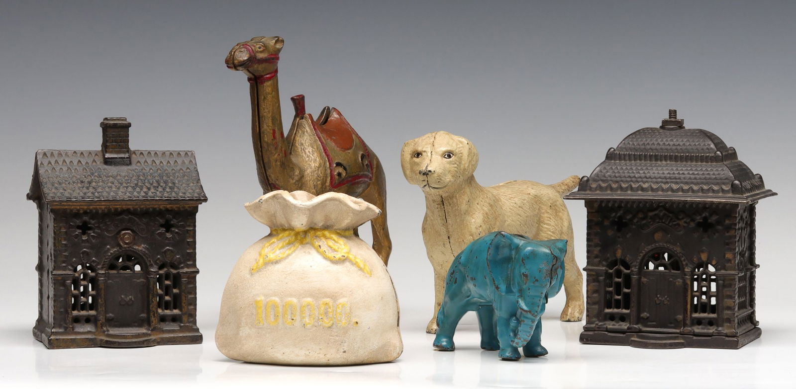 FOUR ANTIQUE CAST IRON STILL BANKS: The collection of original antique cast iron banks in original finish is offered as shown, the money bag looks to be a reproduction, no other reproductions. Ranges from 3 to 7.25 inches tall. Without