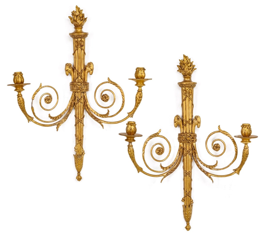 A PAIR OF LATE 20TH C. TORCH BACK GILT WOOD SCONCES: The torch form back plates are mounted with scrolling acanthus arms having mounted with ram's heads. Measures 26 x 21 inches. Without proof of exemption, be aware that internet sales tax applies to al