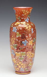 A MOSER 15-INCH GILT AND ENAMEL VASE WITH INSECTS: The outstanding baluster form cranberry glass vase, cased with a thin layer of opalescence, is profusely decorated in an all-over relief pattern of gold berries and polychrome enamel leaves
