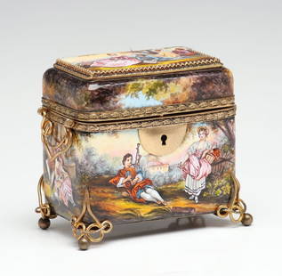 CIRCA 1900 VIENNESE ENAMEL DRESSER BOX WITH FIVE SCENES: The fully enameled box is decorated with 18th century courting scenes and raised on brass mounts that bear a striking resemblance to those used on the Moser art glass caskets in this collection.