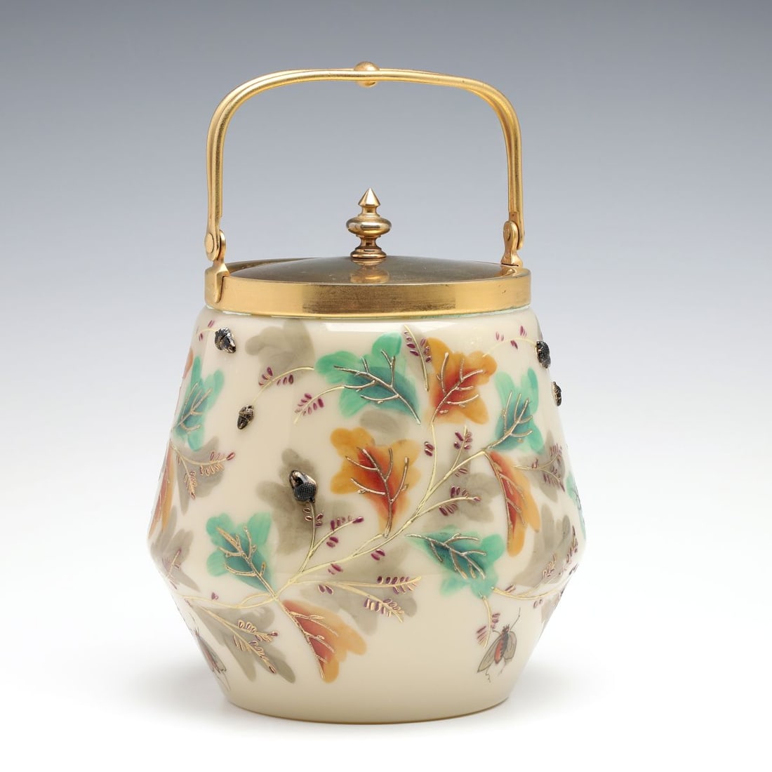 A SCARCE MOSER BISCUIT JAR WITH COBALT BLUE ACORNS: The clambroth colored blown glass jar is decorated with leaves in fall colors and twelve glass acorn applications in dark cobalt blue. Measures 8 x 6.5 inches, not including the handle. Without proof 