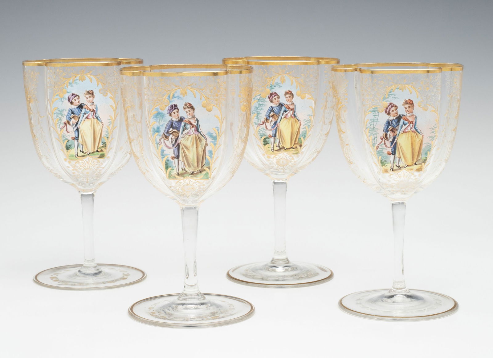 MOSER QUATREFOIL SHAPE WINES WITH ENAMEL COURTING SCENE: Ludwig Moser Late 19th Century The colorless crystal wines are blown with the typical circular foot supporting a short stem supporting an unusual bowl of squarish form having four pleats creating a fo