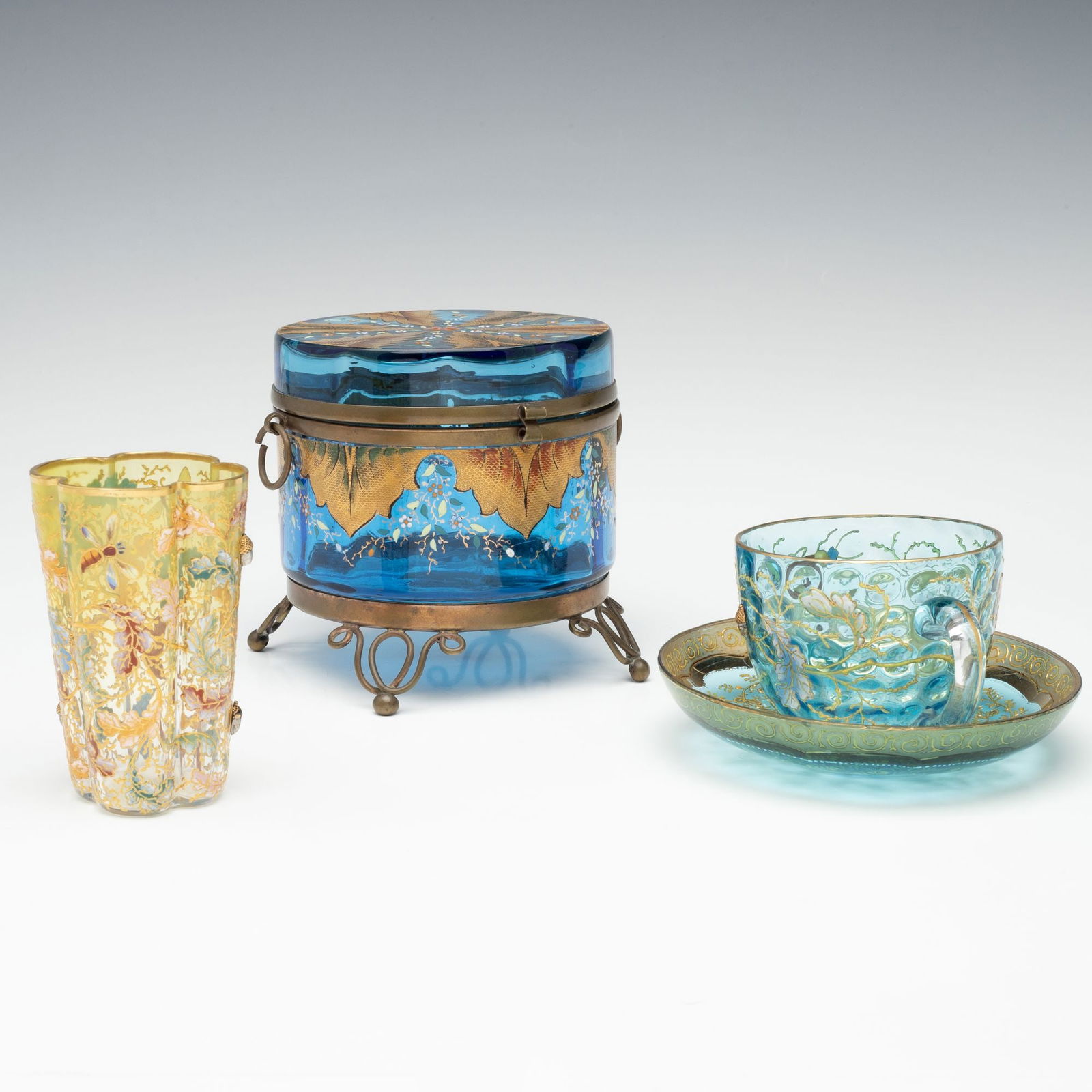 MOSER ART GLASS ARTICLES WITH APPLIED ACORNS ACCENTS: Ludwig Moser Early 20th Century Including. 1. A quatrefoil-shaped glass tumbler shaded citron to clear and decorated in high relief enamels of insects amid oak boughs in colorful relief enamels accent