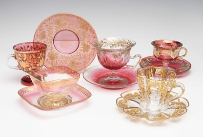 FIVE ELABORATE ART GLASS FOOTED CUP SAUCER SETS