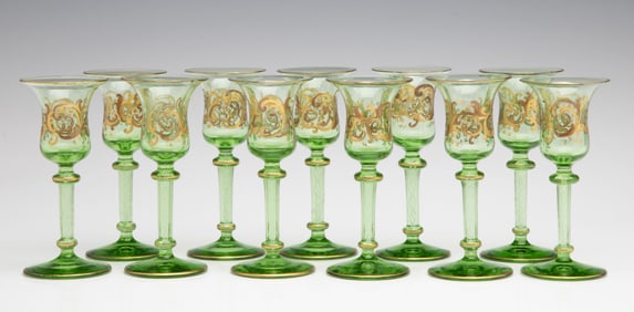 ELEVEN GREEN CRYSTAL CORDIALS WITH LATTICINO CORE STEMS