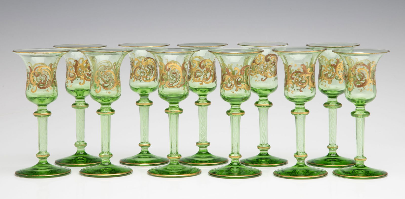 ELEVEN GREEN CRYSTAL CORDIALS WITH LATTICINO CORE STEMS (1 of 16)