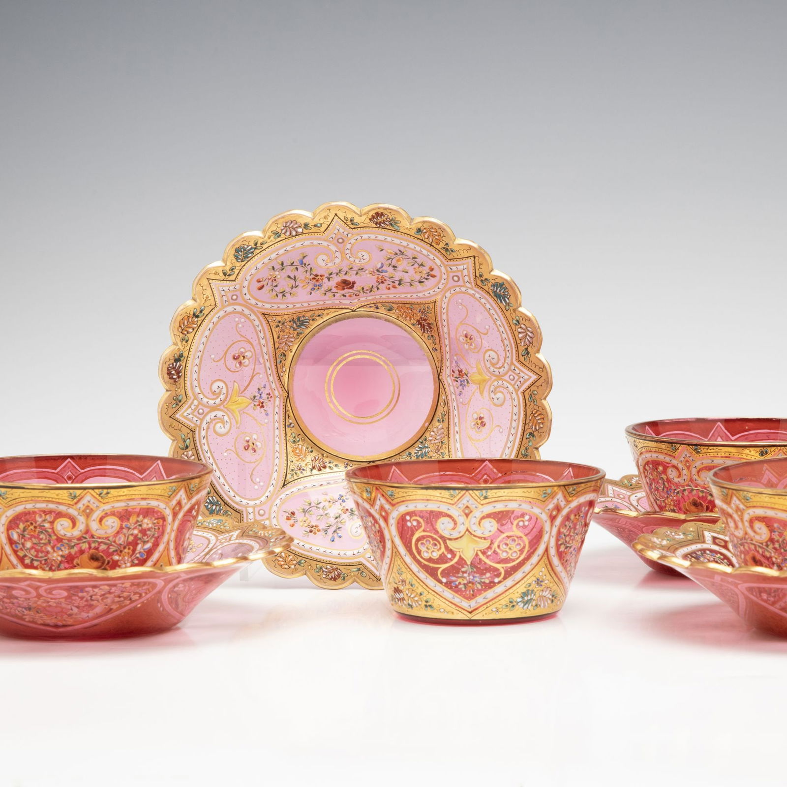 MOSER GILT AND ENAMEL FINGER BOWLS WITH UNDERPLATE: Ludwig Moser Early 20th Century Each blown glass bowl and underplate is decorated in elaborate raised polychrome enamels framed in gold. Bowls measure 1.75 x 3.25, underplates are 5.25 inches each. Wi