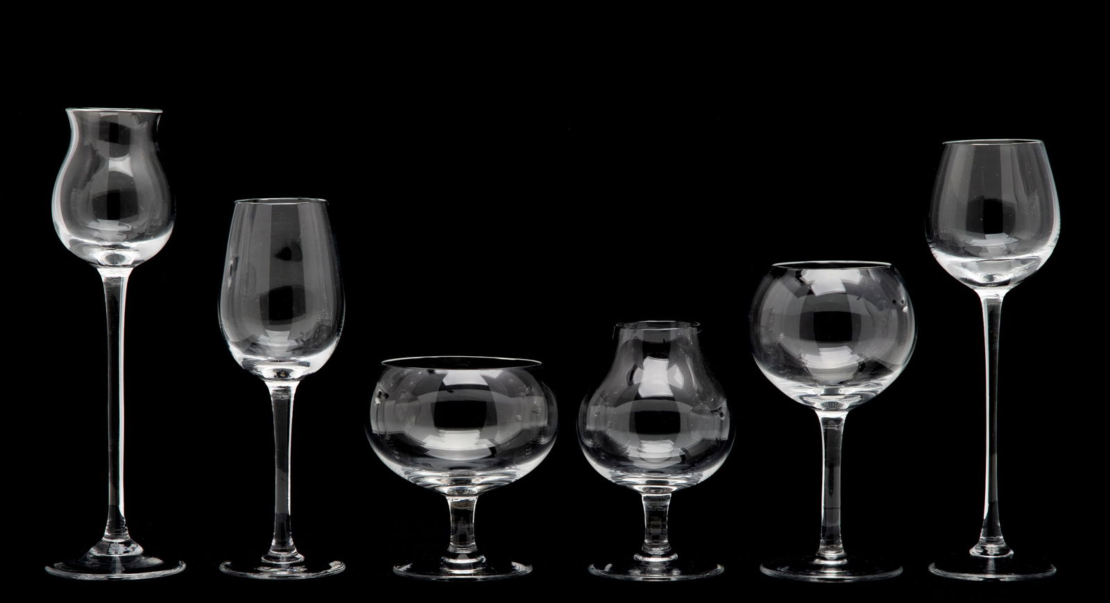 SIX MOSER BLOWN CRYSTAL SNIFTERS IN PRESENTATION CASE: Ludwig Moser Early 20th Century 'The Moser Club's Physiognomical Snifters.' Measure from 2.75 to 5.75 inches. The case is 8 x 10.75 x 3.5 inches. Without proof of exemption, be aware that internet sal