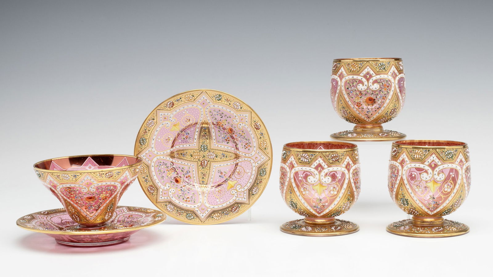 A MOSER SHERBET ON UNDERPLATE WITH ALTERED GOBLETS: Ludwig Moser Early 20th Century This lot is comprised of a sherbet on matching underplate, an unrelated saucer, and three pieces that were created by cutting and removing the stem portion from three w