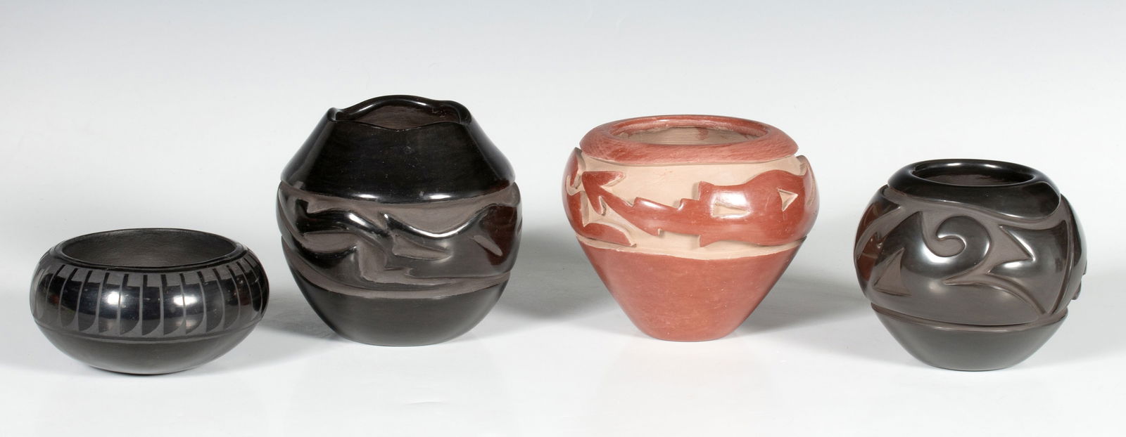 ARTIST-SIGNED SANTA CLARA AND SAN ILDEFONSO POTTERY: 1) Julia Martinez (Santa Clara) carved blackware vase. 2) Mida Tafoya (Santa Clara, born 1931) carved redware vase. 3) Gracie Naranjo (Santa Clara, 1938-2002) carved blackware vase. 4) Lorenzo Gonzale