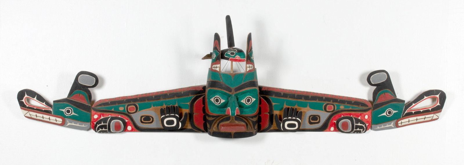 ED RAUB NORTHWEST COAST SISIUTL MASK: Carved and painted mask signed Ed Raub (Makah, 20th century). The large detailed carving painted in natural pigments depicts Sisiutl, the powerful and mythical creature often depicted as a double-head